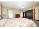 Bedroom with four poster bed, floral bedding, closet, and dresser; carpet with floral pattern at 345 E Main St, Jamestown, IN 46147