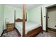 Bedroom with four-poster bed, wooden floors, and green walls at 345 E Main St, Jamestown, IN 46147