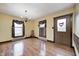 Sunny dining room with hardwood floors, a chandelier, and a doorway leading outside at 345 E Main St, Jamestown, IN 46147