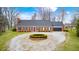 Inviting single-story brick home with a circular driveway and attached garage, offering classic curb appeal at 345 E Main St, Jamestown, IN 46147