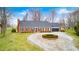 Charming single-story brick home featuring a circular driveway, attached garage, and well-maintained landscaping at 345 E Main St, Jamestown, IN 46147
