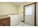 Laundry room featuring cream walls, white door, cabinet and washer and dryer at 345 E Main St, Jamestown, IN 46147