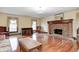 Inviting living room with hardwood floors, a brick fireplace, and abundant natural light at 345 E Main St, Jamestown, IN 46147