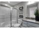 Modern bathroom with a glass-enclosed shower, gray vanity, and sleek finishes at 3598 Planck Cir, Danville, IN 46122