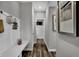 Inviting hallway with wood-look flooring and convenient mudroom setup with coat rack and seating area at 3598 Planck Cir, Danville, IN 46122