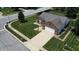 Aerial view of a brick single-Gathering home with a driveway, well-maintained lawn, and mature trees in a suburban neighborhood at 401 Paddlebrook Dr, Danville, IN 46122