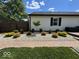Well-manicured backyard featuring gravel beds, shrubs, a small tree, and a wood deck at 401 Paddlebrook Dr, Danville, IN 46122
