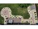 Aerial view of backyard featuring a fire pit, landscaping, a wood deck with patio seating and a storage shed at 401 Paddlebrook Dr, Danville, IN 46122
