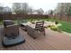 Spacious backyard with a wooden deck and patio furniture, surrounded by a well-maintained lawn at 401 Paddlebrook Dr, Danville, IN 46122