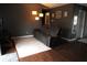 Cozy living room featuring hardwood floors, a leather sofa with side tables, and a modern floor lamp at 401 Paddlebrook Dr, Danville, IN 46122
