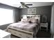 A primary bedroom features a king bed, decorative windows, and neutral color scheme at 401 Paddlebrook Dr, Danville, IN 46122