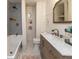 Updated bathroom features a tub with shower, and stylish vanity with marble countertops at 4030 N Illinois St, Indianapolis, IN 46208