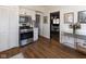 Galley kitchen with stainless steel stove, microwave, and white cabinets, leads to dining room at 4030 N Illinois St, Indianapolis, IN 46208