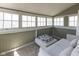 Bright sunroom with multiple windows and comfortable seating makes a serene space at 4030 N Illinois St, Indianapolis, IN 46208