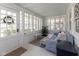 Bright sunroom features many windows, white brick walls, and stylish furnishings at 4030 N Illinois St, Indianapolis, IN 46208