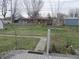 A tranquil backyard featuring a walkway, grassy area, and chain link fence at 406 W Jackson St, Alexandria, IN 46001