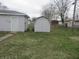 View of back yard with multiple outbuildings and chain link fence at 406 W Jackson St, Alexandria, IN 46001
