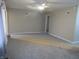 Spacious living room with neutral carpet, a ceiling fan, and fresh paint, offering a blank canvas at 406 W Jackson St, Alexandria, IN 46001