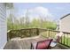 Outdoor deck with seating overlooks a lush backyard with mature trees and landscaping at 4196 Parliament Way, Avon, IN 46123