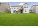 Large, well-manicured backyard with a wooden deck, stairs, and lush green grass at 4196 Parliament Way, Avon, IN 46123