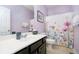 Charming bathroom features a butterfly shower curtain, single vanity and a decorated mirror at 4196 Parliament Way, Avon, IN 46123