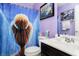 Colorful bathroom with a shower featuring a themed curtain, vanity with sink, and decorative accents at 4196 Parliament Way, Avon, IN 46123