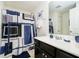 Bathroom with a single vanity, a mirror, a patterned shower curtain, and tiled flooring at 4196 Parliament Way, Avon, IN 46123