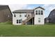 Rear exterior view of a home featuring a wooden deck with stairs and a lush green lawn at 4196 Parliament Way, Avon, IN 46123