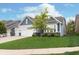 Charming home showing a three-car garage, and manicured lawn surrounded by tidy landscaping at 4196 Parliament Way, Avon, IN 46123