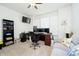 Functional home office with multiple monitors, a comfortable couch, and natural light from the windows at 4196 Parliament Way, Avon, IN 46123