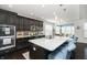 Modern kitchen featuring dark cabinetry, quartz countertops, a large center island, and stylish pendant lighting at 4196 Parliament Way, Avon, IN 46123