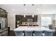 Modern kitchen featuring dark cabinetry, quartz countertops, a large center island, and stainless steel appliances at 4196 Parliament Way, Avon, IN 46123