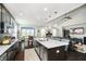 Open kitchen layout featuring dark cabinetry, quartz countertops, a large center island, and hardwood floors at 4196 Parliament Way, Avon, IN 46123