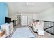 Open loft space with neutral tones, a ceiling fan, seating area, tv and built-in shelving at 4196 Parliament Way, Avon, IN 46123