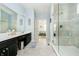 Bright main bathroom featuring a glass shower, double vanity sinks, and views to the main bedroom at 4196 Parliament Way, Avon, IN 46123