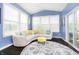 Bright sunroom with vaulted ceilings, large windows, and a comfortable seating area with a decorative rug at 4196 Parliament Way, Avon, IN 46123