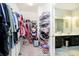 Walk-in closet with clothing racks, shelves, and shoe storage, connected to a full bathroom at 4196 Parliament Way, Avon, IN 46123