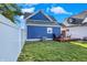 Backyard with deck and seating area, surrounded by a well-manicured lawn and white fencing at 424 N Randolph St, Indianapolis, IN 46201