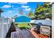 Expansive backyard with a wooden deck, a lush lawn, and white fencing, offering a private outdoor space at 424 N Randolph St, Indianapolis, IN 46201