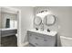 Modern bathroom featuring a gray double vanity with round mirrors and view to the bedroom at 424 N Randolph St, Indianapolis, IN 46201