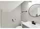 Cozy bathroom with a single vanity, round mirror, toilet, and shower at 424 N Randolph St, Indianapolis, IN 46201