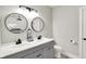 Modern bathroom with double sinks, granite countertop, and black hardware at 424 N Randolph St, Indianapolis, IN 46201