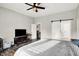 Bedroom featuring hardwood floors, a large closet, a ceiling fan, and a TV on the wall at 424 N Randolph St, Indianapolis, IN 46201