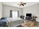 Bedroom with a ceiling fan, hardwood floors, and a large window at 424 N Randolph St, Indianapolis, IN 46201