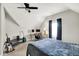 Bedroom with sloped ceilings, a ceiling fan, a desk, and multiple guitars at 424 N Randolph St, Indianapolis, IN 46201