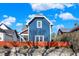 Charming blue two-story home with a vibrant orange fence and landscaped yard at 424 N Randolph St, Indianapolis, IN 46201