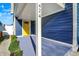 Inviting covered front porch featuring vibrant yellow door at 424 N Randolph St, Indianapolis, IN 46201