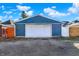 Detached two car garage with a white door and blue siding underneath a partly cloudy sky at 424 N Randolph St, Indianapolis, IN 46201
