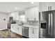 Updated kitchen featuring white cabinets, modern appliances, and tile backsplash at 424 N Randolph St, Indianapolis, IN 46201