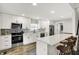 Modern kitchen featuring white cabinets, stainless steel appliances, and bar stool seating at 424 N Randolph St, Indianapolis, IN 46201